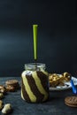 Chocolate spread or nougat cream with hazelnuts in a glass jar on a dark wooden background Royalty Free Stock Photo