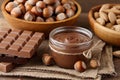 Chocolate spread with hazelnuts on wooden background Royalty Free Stock Photo