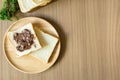 Chocolate spread on slice of bread on the wood plate. Royalty Free Stock Photo