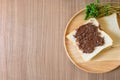 Chocolate spread on slice of bread on the wood plate. Royalty Free Stock Photo