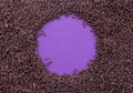 Chocolate sprinkles covering a purple background leaving a circle in centre for text