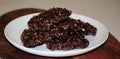 Chocolate square biscuits with nuts on a white round plate Royalty Free Stock Photo