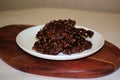 Chocolate square biscuits with nuts on a white round plate Royalty Free Stock Photo