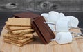 Chocolate squares, graham crackers, marshmallows and skewers