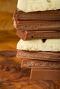 Chocolate stack of dark and white chocolate with brown background