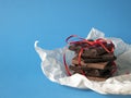 Chocolate stack wrapped up with a red ribbon, copy space. Concept of sweet present, pleasant gift