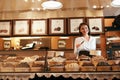 Chocolate Store. Female Seller In Confectionery Shop.