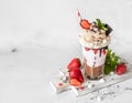 Chocolate and strawberry milkshake with ice cream and whipped cream, mini meringue, chocolate, strawberry and mint served in a Royalty Free Stock Photo