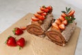 Chocolate strawberry roll cake. Sponge roll with blueberries Royalty Free Stock Photo