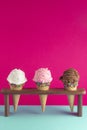 Chocolate Strawberry and Vanilla Ice Cream Cones with Sprinkles on a Pink Background Royalty Free Stock Photo