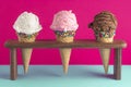 Chocolate Strawberry and Vanilla Ice Cream Cones with Sprinkles on a Pink Background Royalty Free Stock Photo