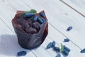 Chocolate sweet cakes muffins with berries on a white wooden table Royalty Free Stock Photo