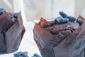 Chocolate sweet cakes muffins with berries on a white wooden table Royalty Free Stock Photo