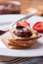 Chocolate sweet melting nougat cream on cookies with strawberries Royalty Free Stock Photo