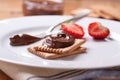 Chocolate sweet melting nougat cream on cookies with strawberries Royalty Free Stock Photo