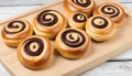 Chocolate swirl buns on wooden chopping board