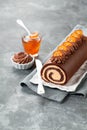 Chocolate swiss roll cake with candied kumquats Royalty Free Stock Photo