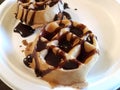 Chocolate syrup liquid on waffles on white plate
