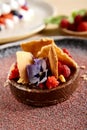 Chocolate tart with muale Honey-almonds and raspberry confit in brown clay plate Royalty Free Stock Photo