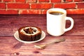 Chocolate tartlets and a cup of strong black coffee on a wooden table Royalty Free Stock Photo