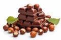 Chocolate tower with hazelnut and leaves on white background. Stack of milk and dark chocolate with nuts. Generative AI