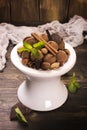 Chocolate truffle candies and assortment of nuts on white stand Royalty Free Stock Photo