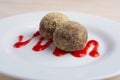 Chocolate truffles with biscuit powder. Rum balls and raspberry jam Royalty Free Stock Photo