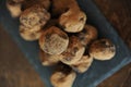 Chocolate truffles in cocoa sprinkled. On the slate board on wooden background. Close-up, texture Royalty Free Stock Photo