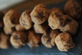 Chocolate truffles in cocoa sprinkled. On the slate board on wooden background. Close-up, texture Royalty Free Stock Photo