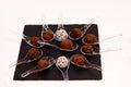 Chocolate truffles covered with cocoa powder in brown wooden bowl with dark chocolate pieces and cocoa powder in wooden spoon. Royalty Free Stock Photo