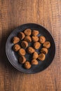 Chocolate truffles covered with cocoa powder on plate on wooden table. Top view Royalty Free Stock Photo