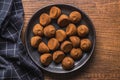 Chocolate truffles covered with cocoa powder on plate on wooden table. Top view Royalty Free Stock Photo