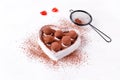 Chocolate truffles on the heart shaped plate Royalty Free Stock Photo