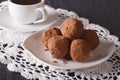 Chocolate truffles on a plate and coffee close-up on the table. Royalty Free Stock Photo