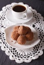 Chocolate truffles on a plate and coffee on the table. vertical Royalty Free Stock Photo