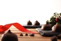 Chocolate truffles on wooden slats and Christmas decoration isolated white Royalty Free Stock Photo