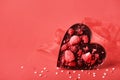 Chocolate valentine heart. Handmade chocolate with freeze-dried berries. Love symbol on red background Royalty Free Stock Photo
