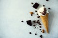 Chocolate, vanilla and coffee ice cream in waffle cone with coffee beans on grey stone background. Summer food concept Royalty Free Stock Photo