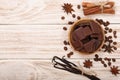 Chocolate, vanilla sticks, cinnamon, coffee beans on white wooden background with copy space for your text. Top view