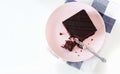 Chocolate vegan brownie cake with nuts. Pink plate. Light background. Selective focus. Royalty Free Stock Photo