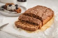 Chocolate vegan zucchini bread with chia pudding and blackberries, white background.