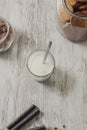 Chocolate wafers, cocoa powder, a jar of cookies and a glass of milk on a rustic wooden background