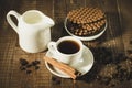 chocolate wafers, creamer and cup of coffee with cinnamon sticks/chocolate wafers, creamer and cup of coffee with cinnamon sticks Royalty Free Stock Photo