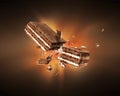 Chocolate waffles broken into two halves with a flash of light in the dark Royalty Free Stock Photo