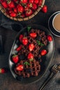 Chocolate waffles with milk and berries for breakfast. Chocolate cookies amerikaner shaped waffles Royalty Free Stock Photo