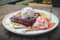 Chocolate waffles with vanilla ice cream, banana, whipped cream Royalty Free Stock Photo