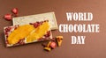 Chocolate white fruit whole tile decorated with slices of fruit nuts on a brown background. Text World Chocolate Day Royalty Free Stock Photo