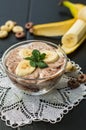 Chocolate yogurt with banana slices and a sprig of mint. Close-up. Top view