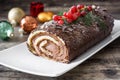 Chocolate yule log cake with red currant