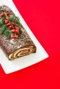 Chocolate yule log christmas cake with red currant Royalty Free Stock Photo